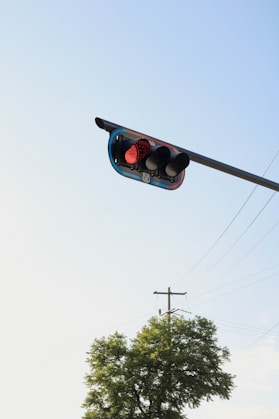 a traffic light hanging from the side of a pole