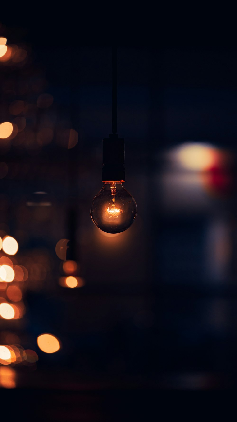 a light bulb hanging from a ceiling in a dark room