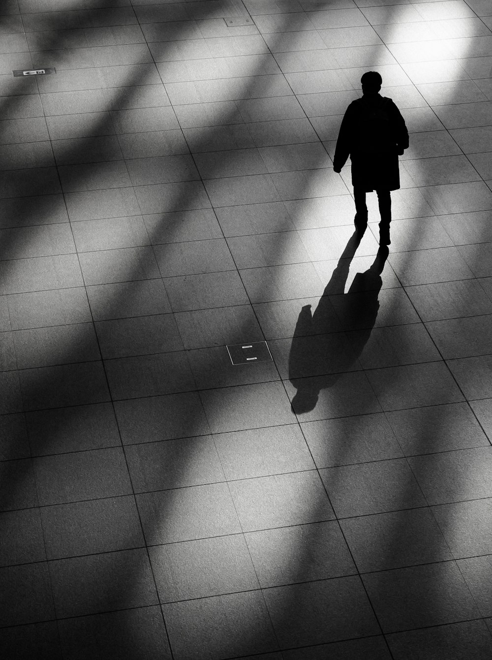 a man standing in a room with a suitcase