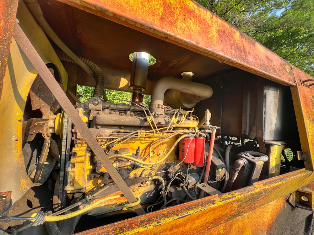 the engine of a large yellow truck is shown