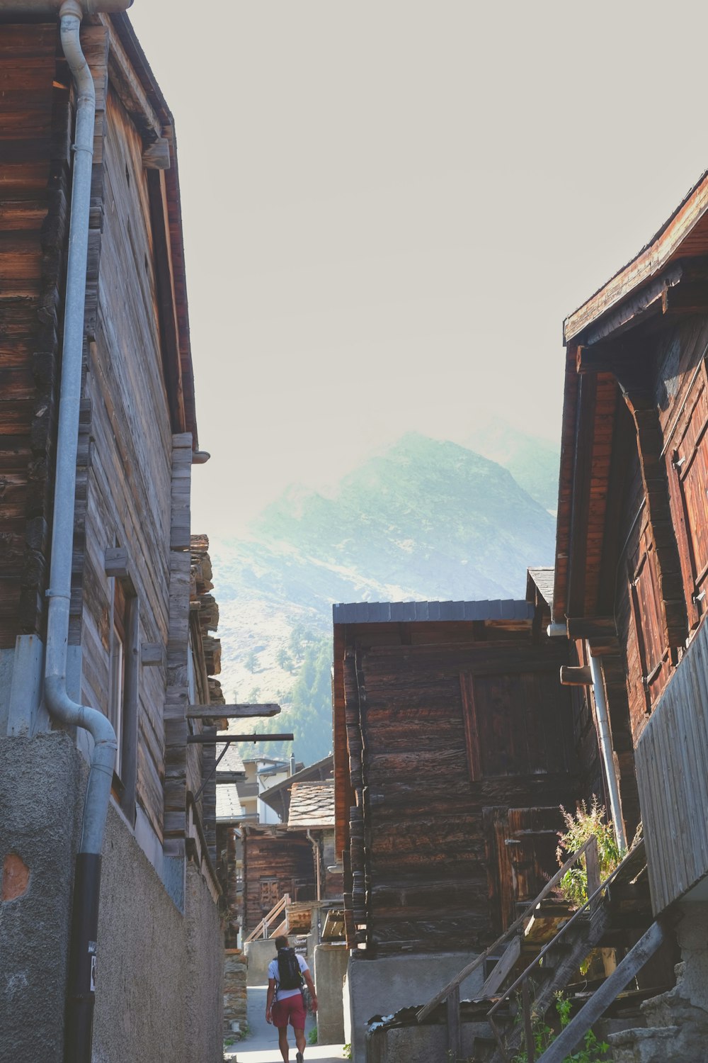 a person walking down a narrow alley way