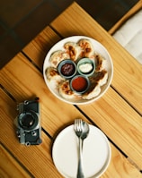 a plate of food on a wooden table