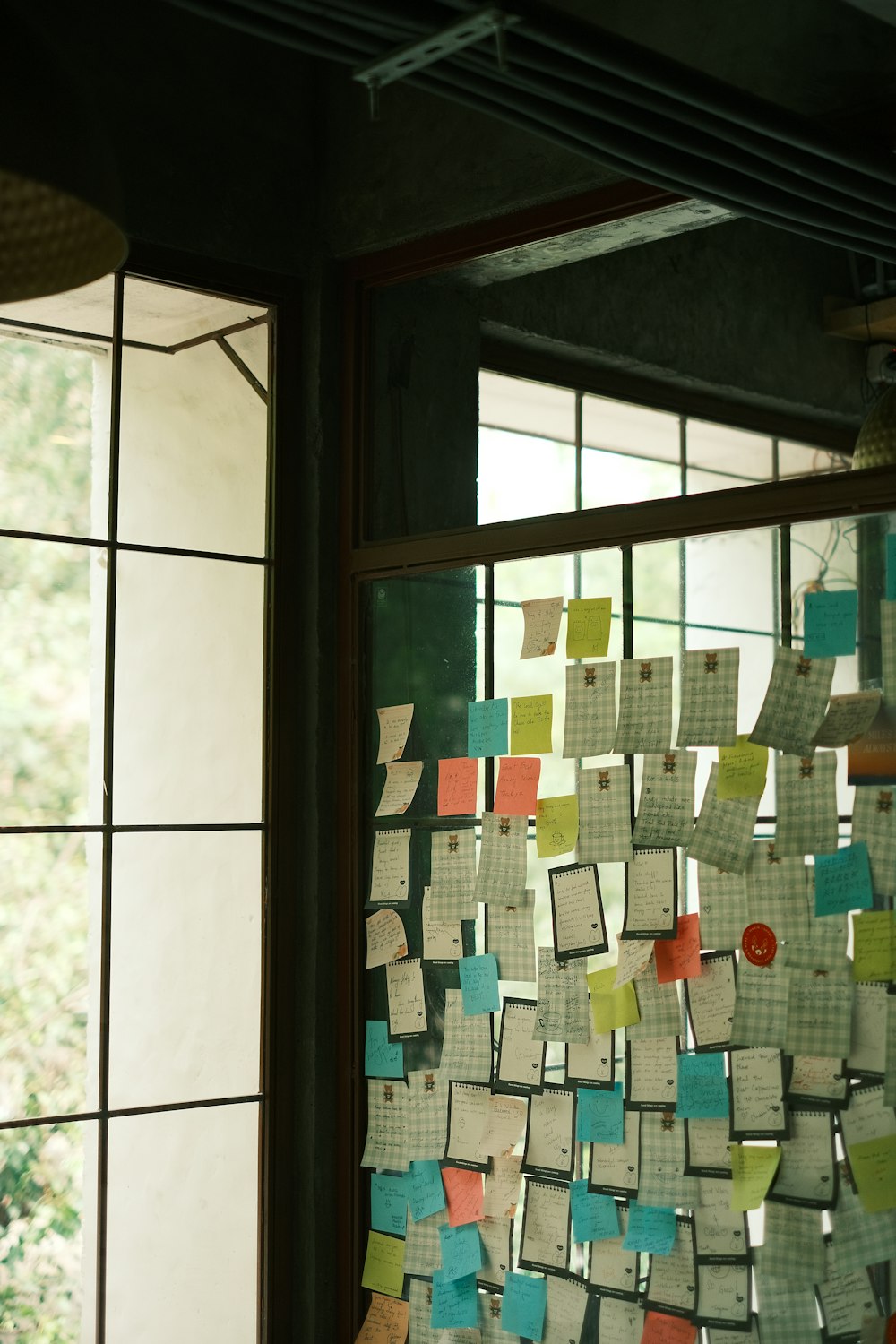 a bunch of post it notes hanging on a wall