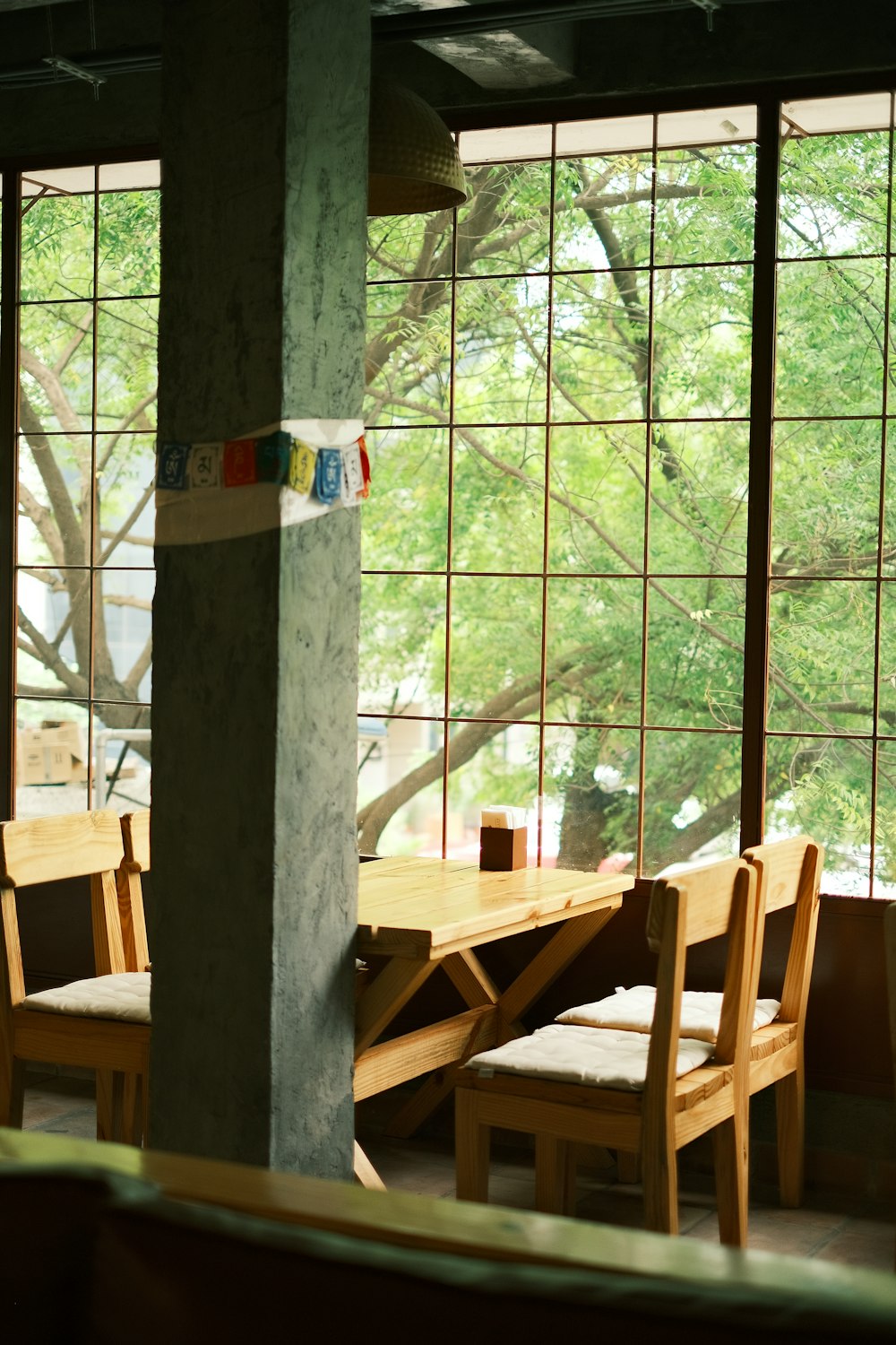 a table and chairs in front of a large window