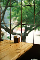 Sunlight filtering through leaves onto a table with eco-friendly packaging materials.