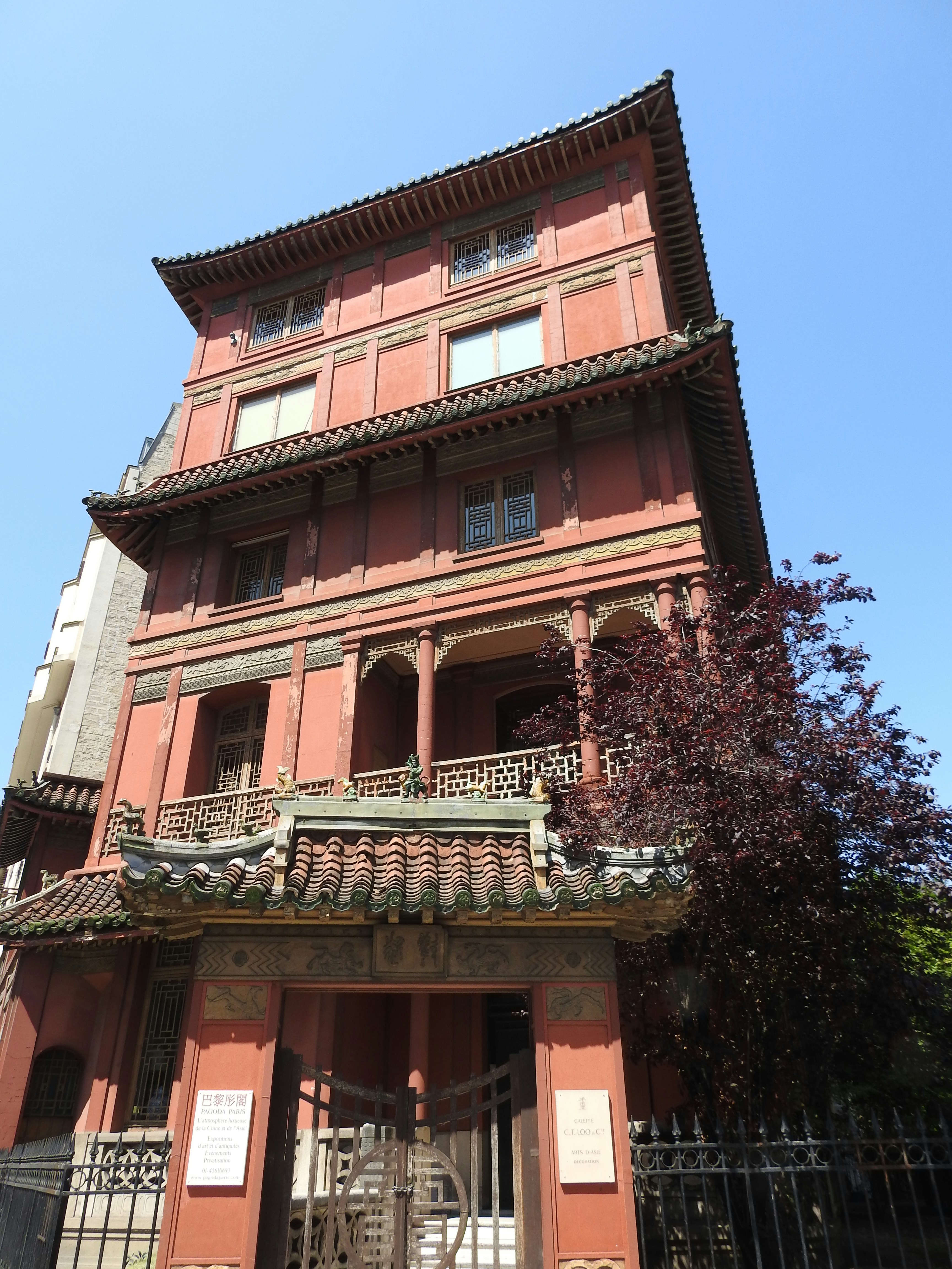 a tall red building with a gate in front of it