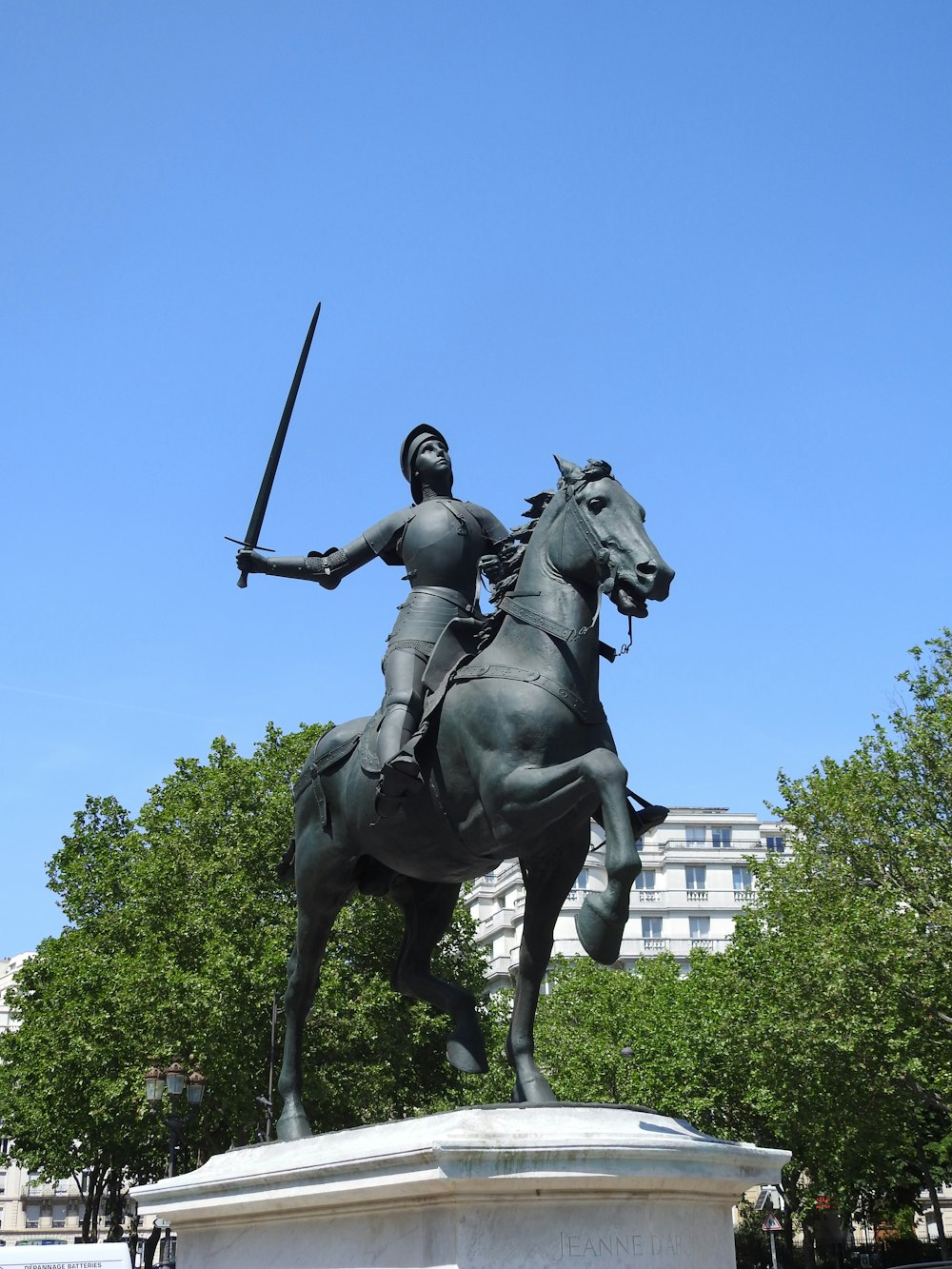 a statue of a man on a horse holding a sword