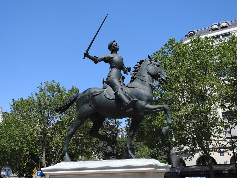 a statue of a man on a horse holding a sword