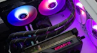 A professional technician assembling a custom gaming PC with precision and care.