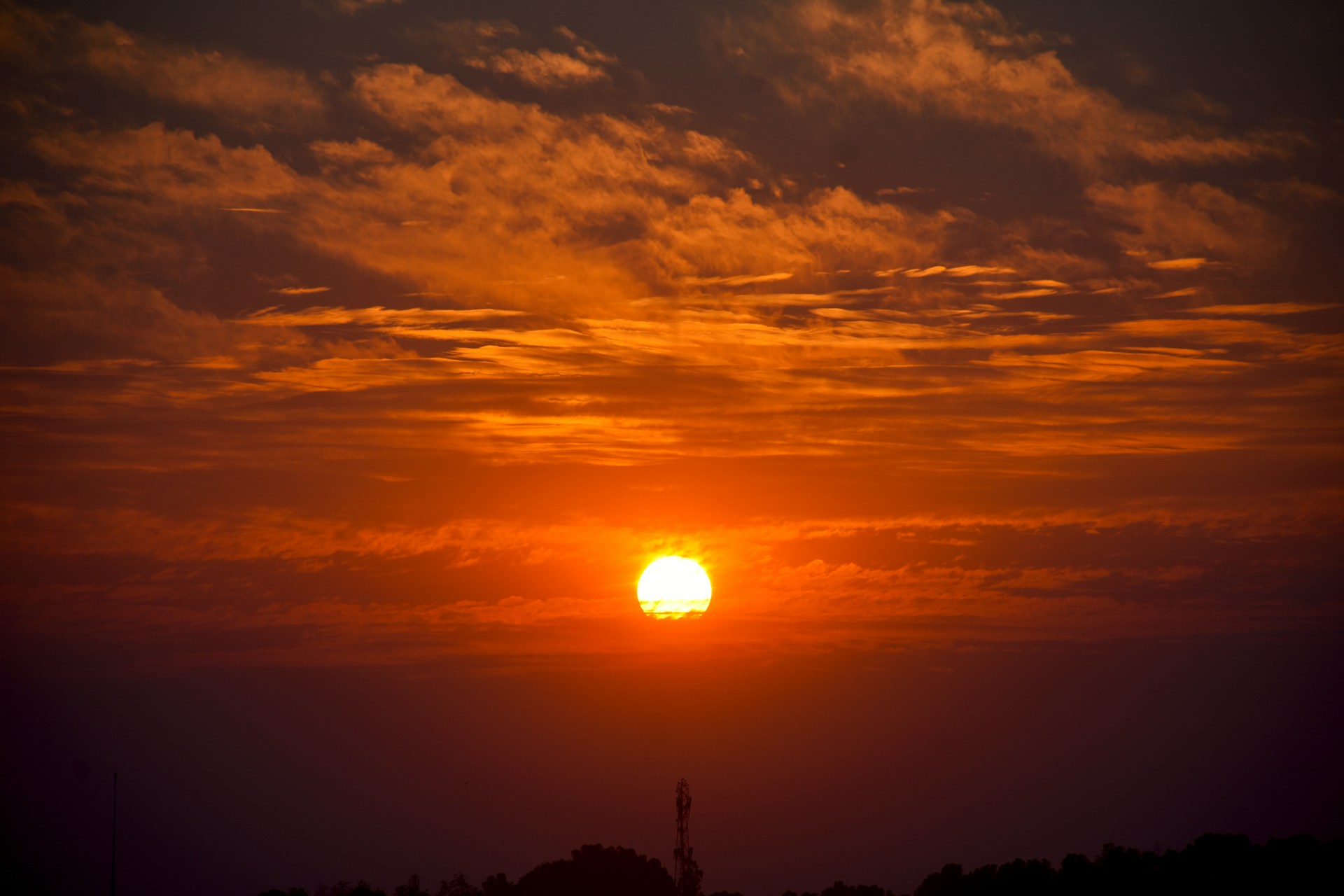 the sun is setting over the horizon of the sky