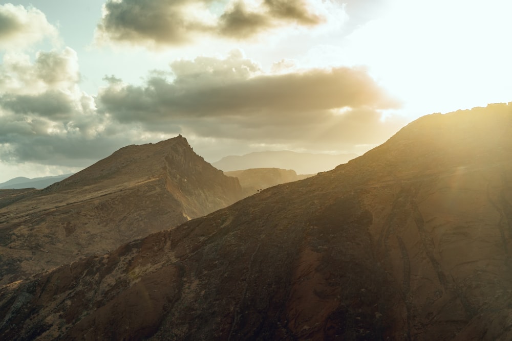 a view of a mountain range with clouds in the sky