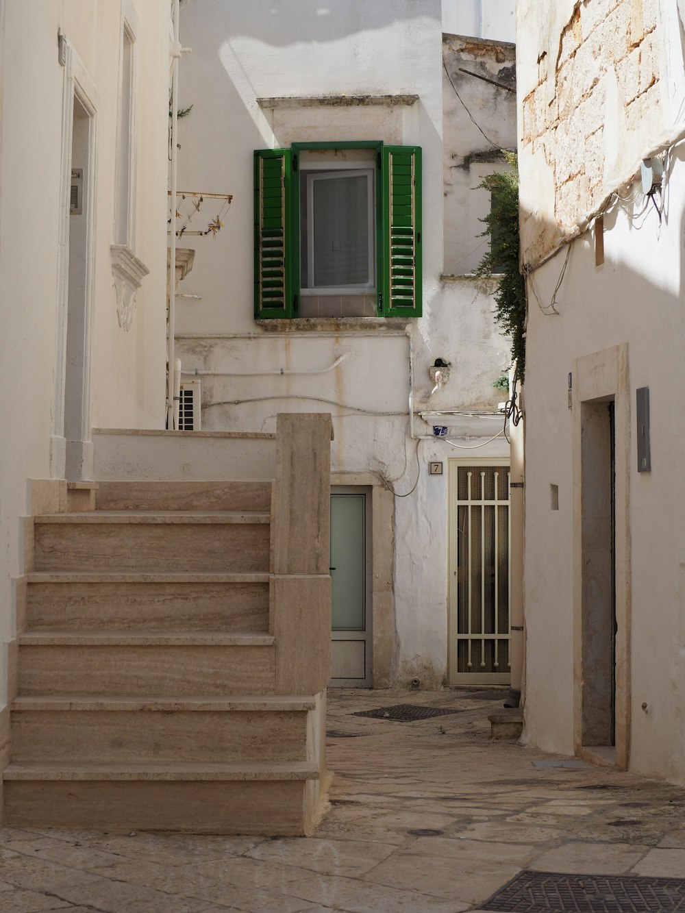 a set of stairs leading to a green window