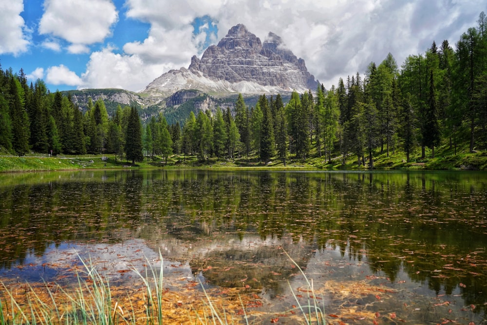 a mountain is reflected in the still water of a lake