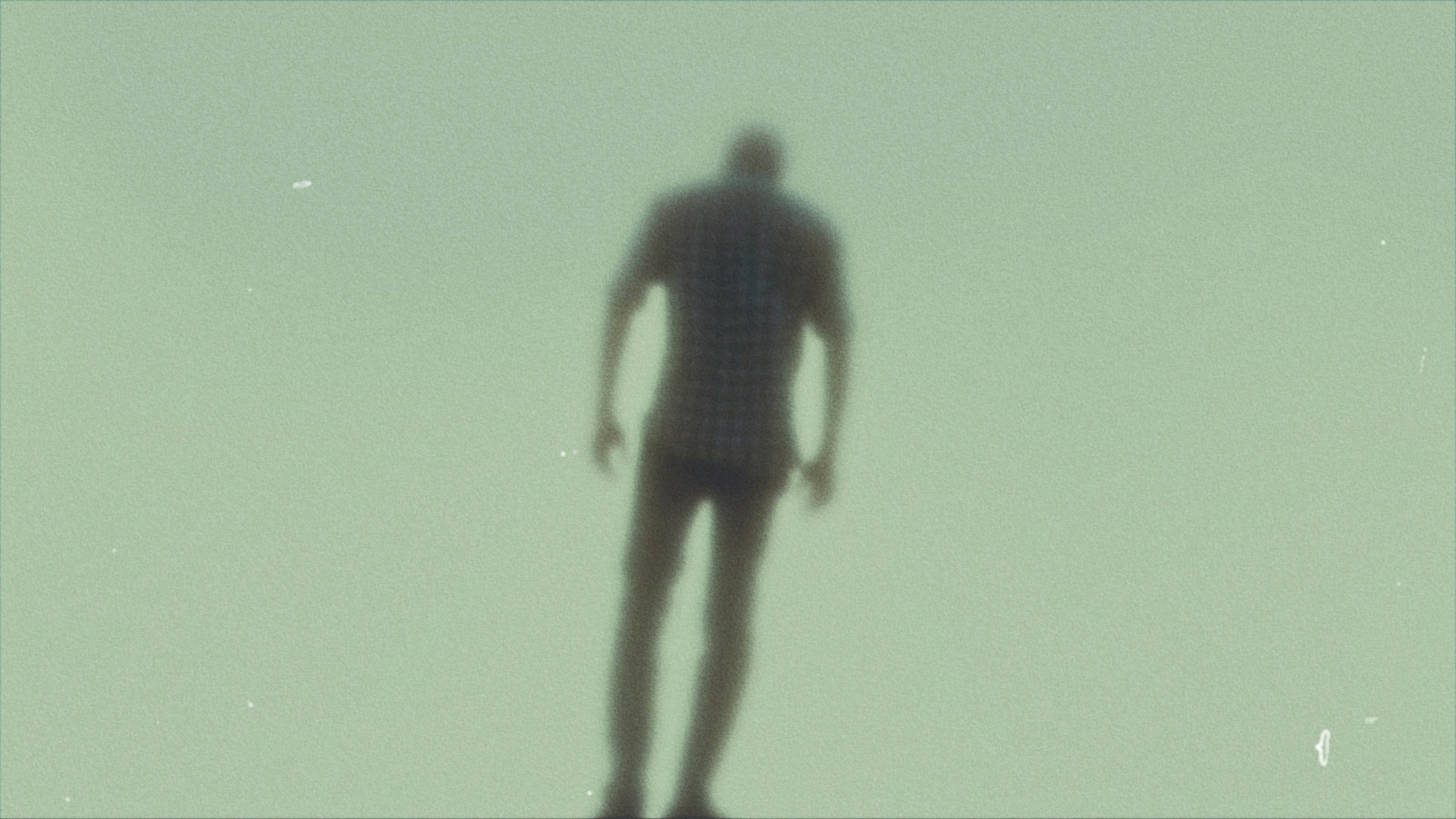 a blurry image of a person standing on a skateboard