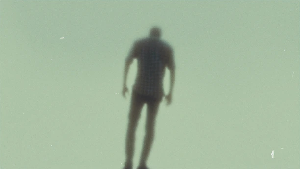 a blurry image of a person standing on a skateboard