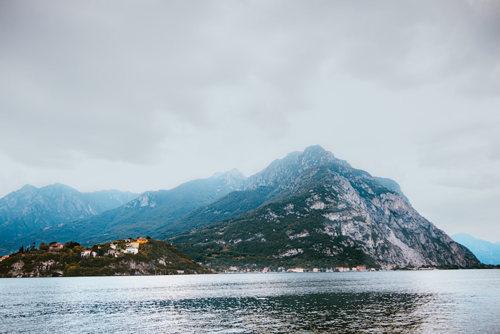 a body of water with mountains in the background