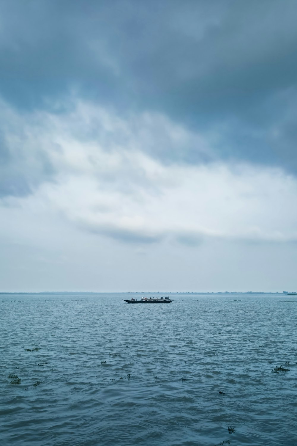 a boat floating on top of a large body of water