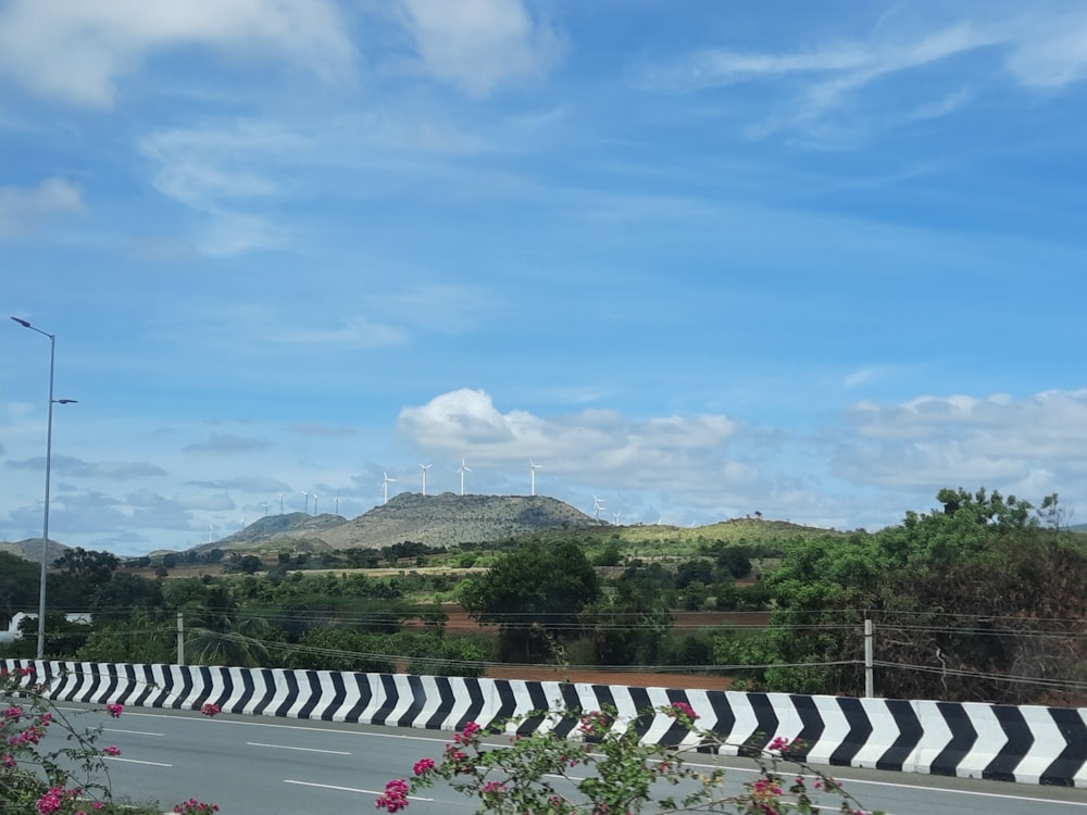 a view of a road with a hill in the background