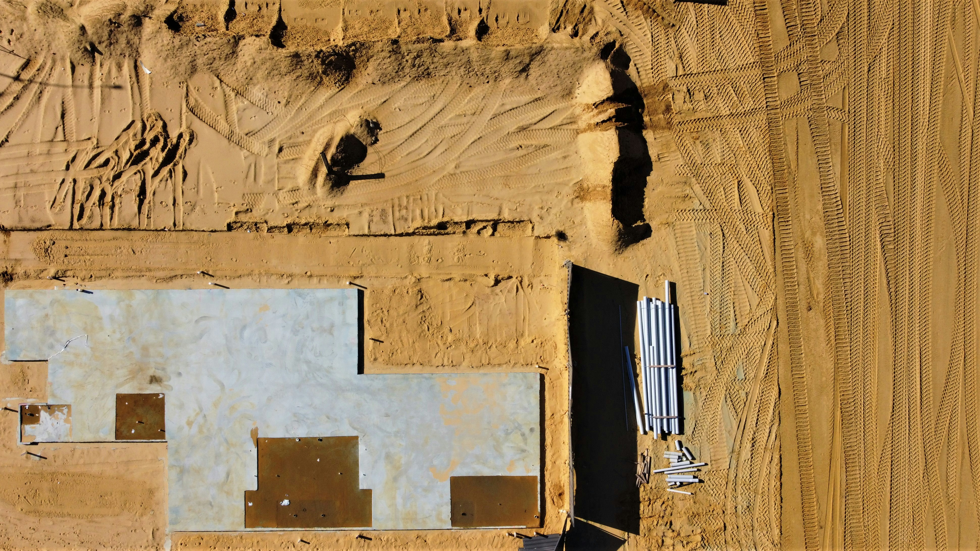 Aerial drone view of building site and surrounding terrain