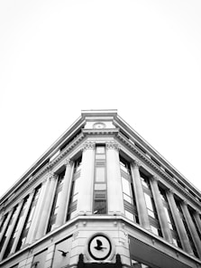 a black and white photo of a clock on a building