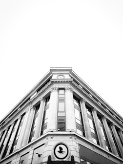a black and white photo of a clock on a building