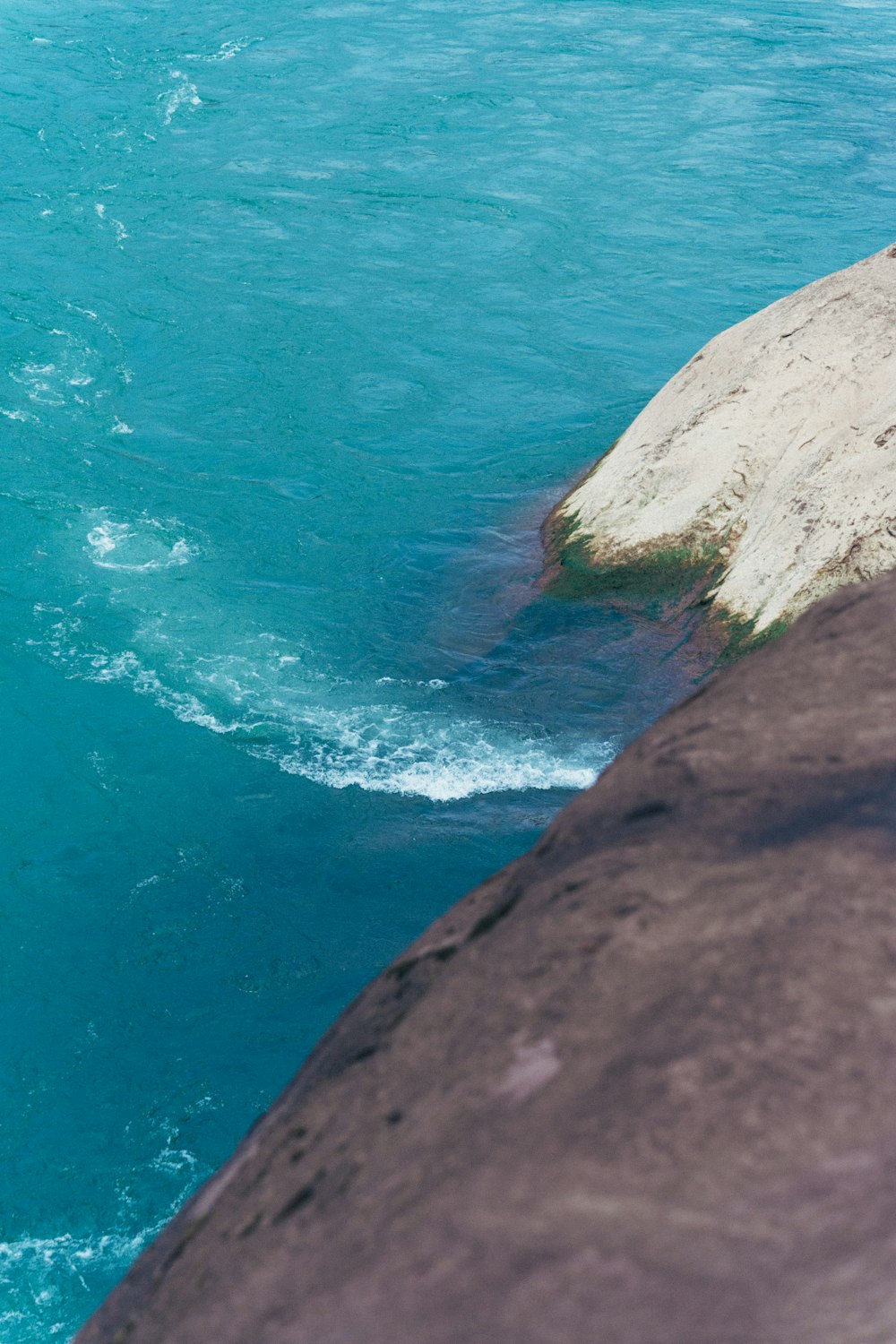 a man riding a surfboard on top of a wave in the ocean