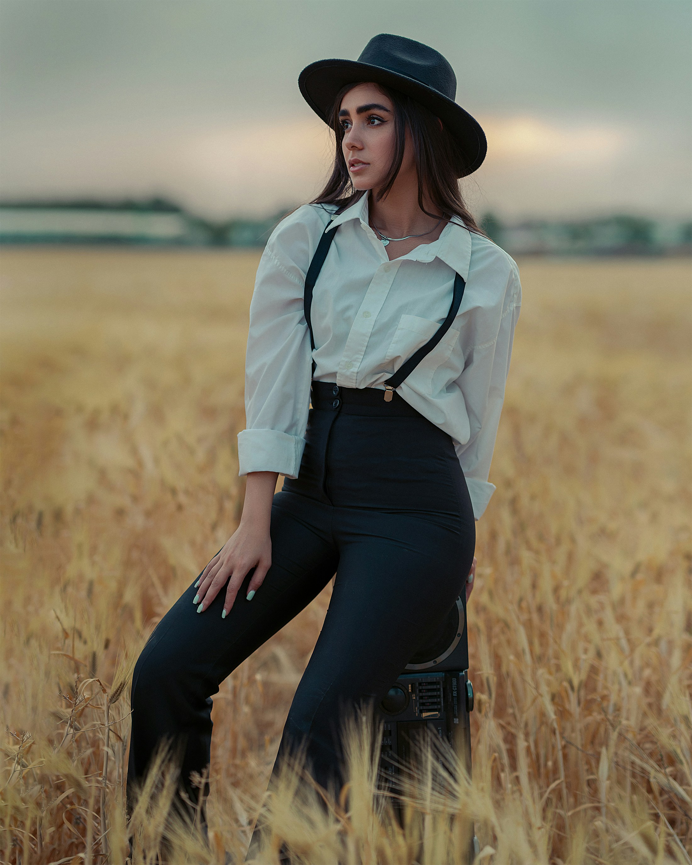 a woman standing in a field of tall grass
