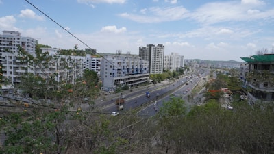 Wide shot of a busy urban road near real estate plots