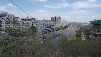 Wide shot of a busy urban road near real estate plots