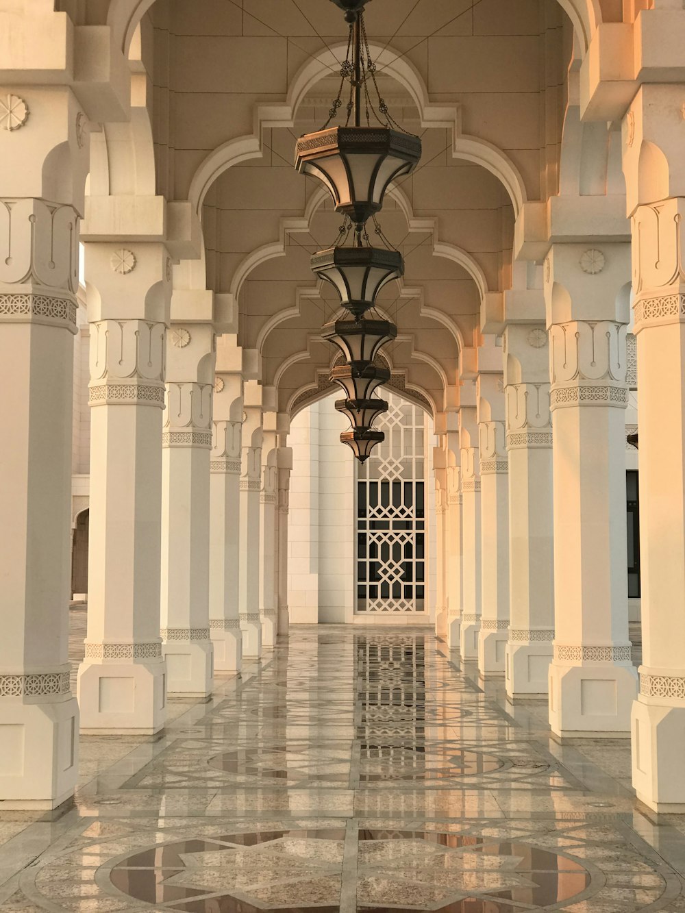 a long hallway with a chandelier hanging from the ceiling