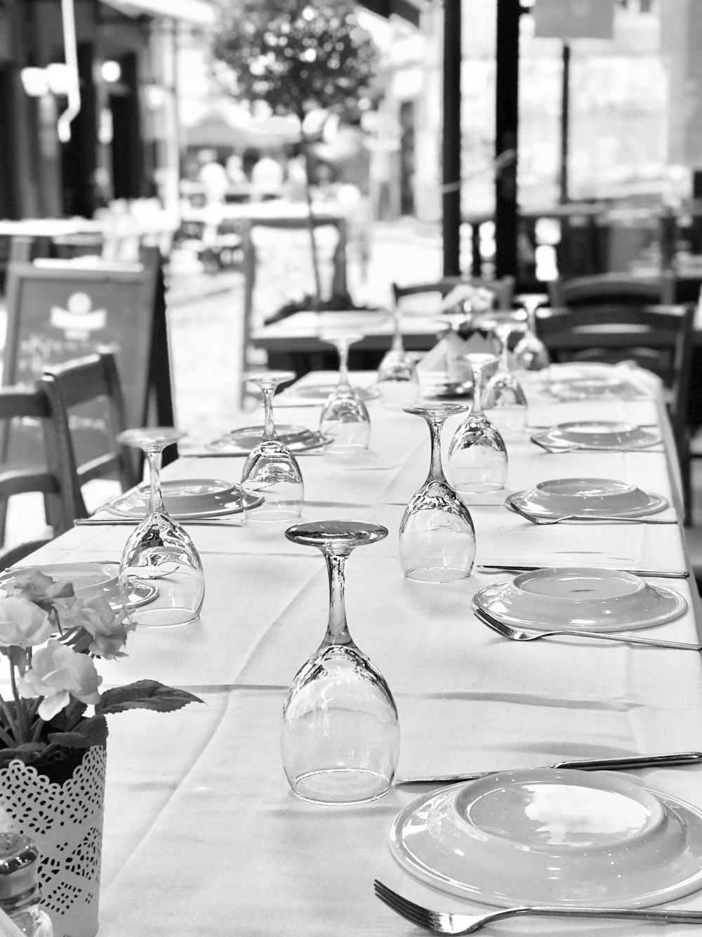 a long table with a vase of flowers on it