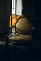 a chair sitting in front of a window in a room