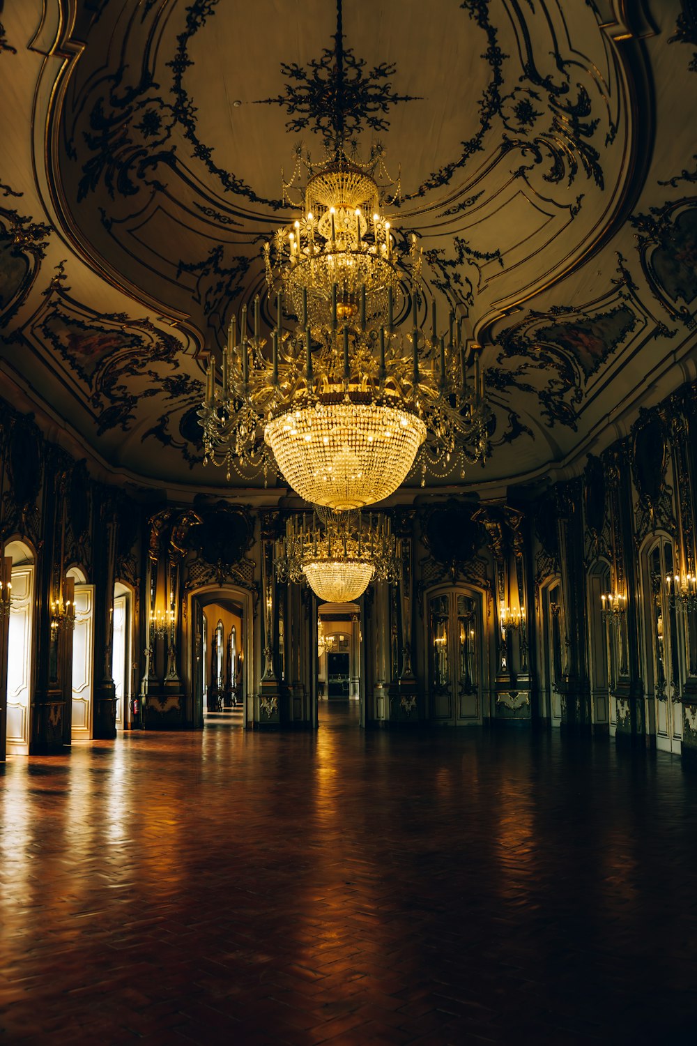 a chandelier hanging from the ceiling of a ballroom