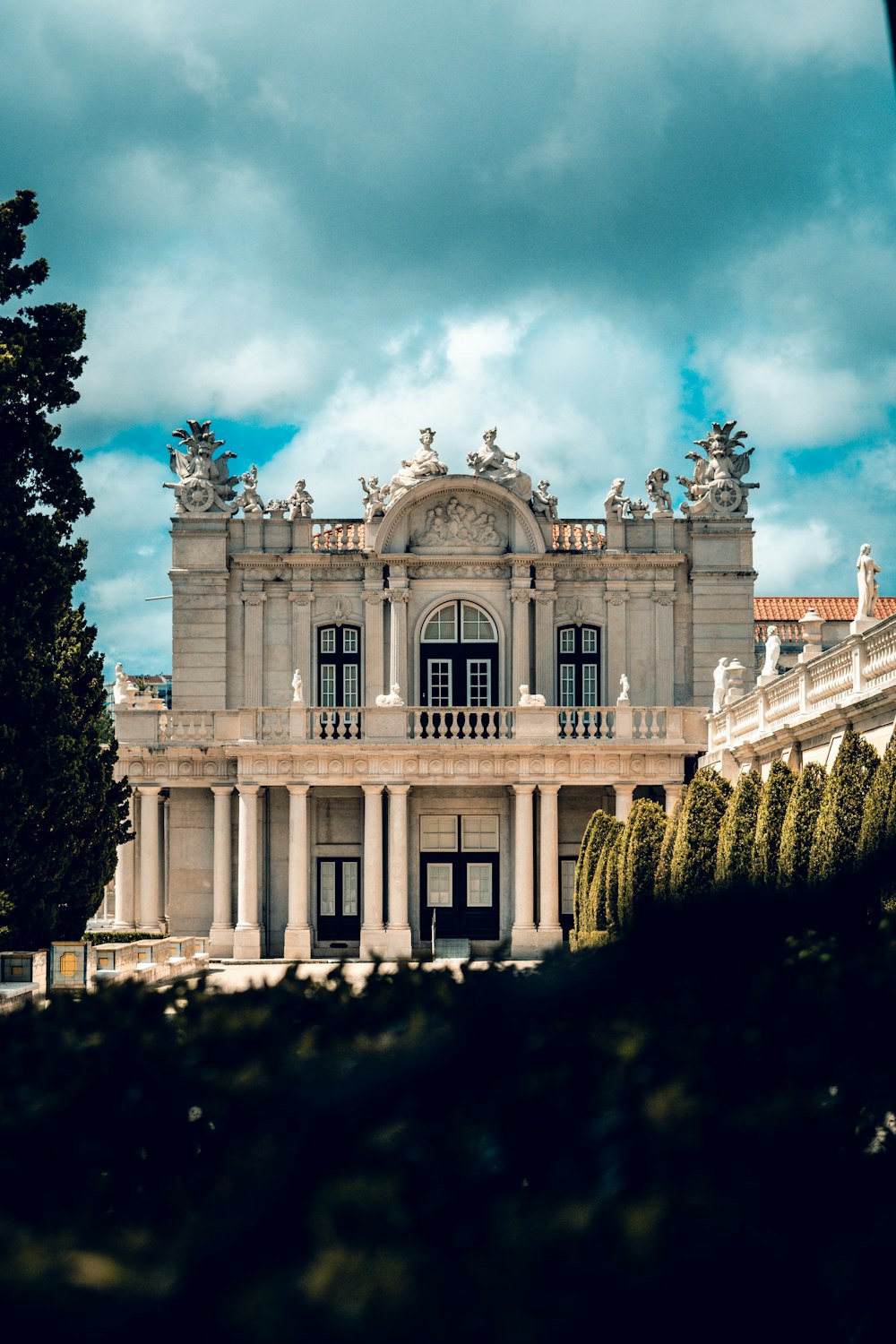 a large white building with a clock on the front of it