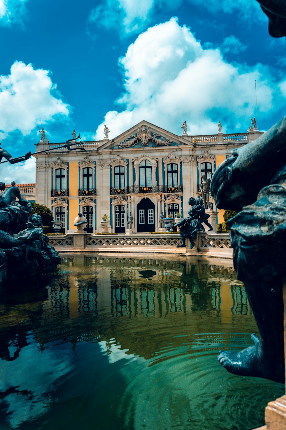 a large building with a fountain in front of it