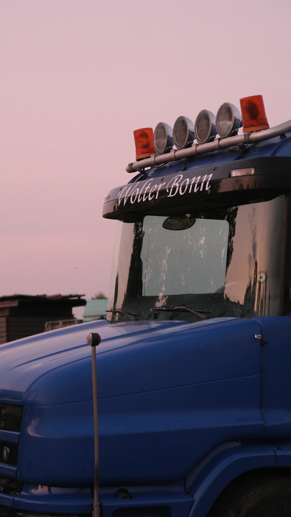 a blue truck parked in a parking lot