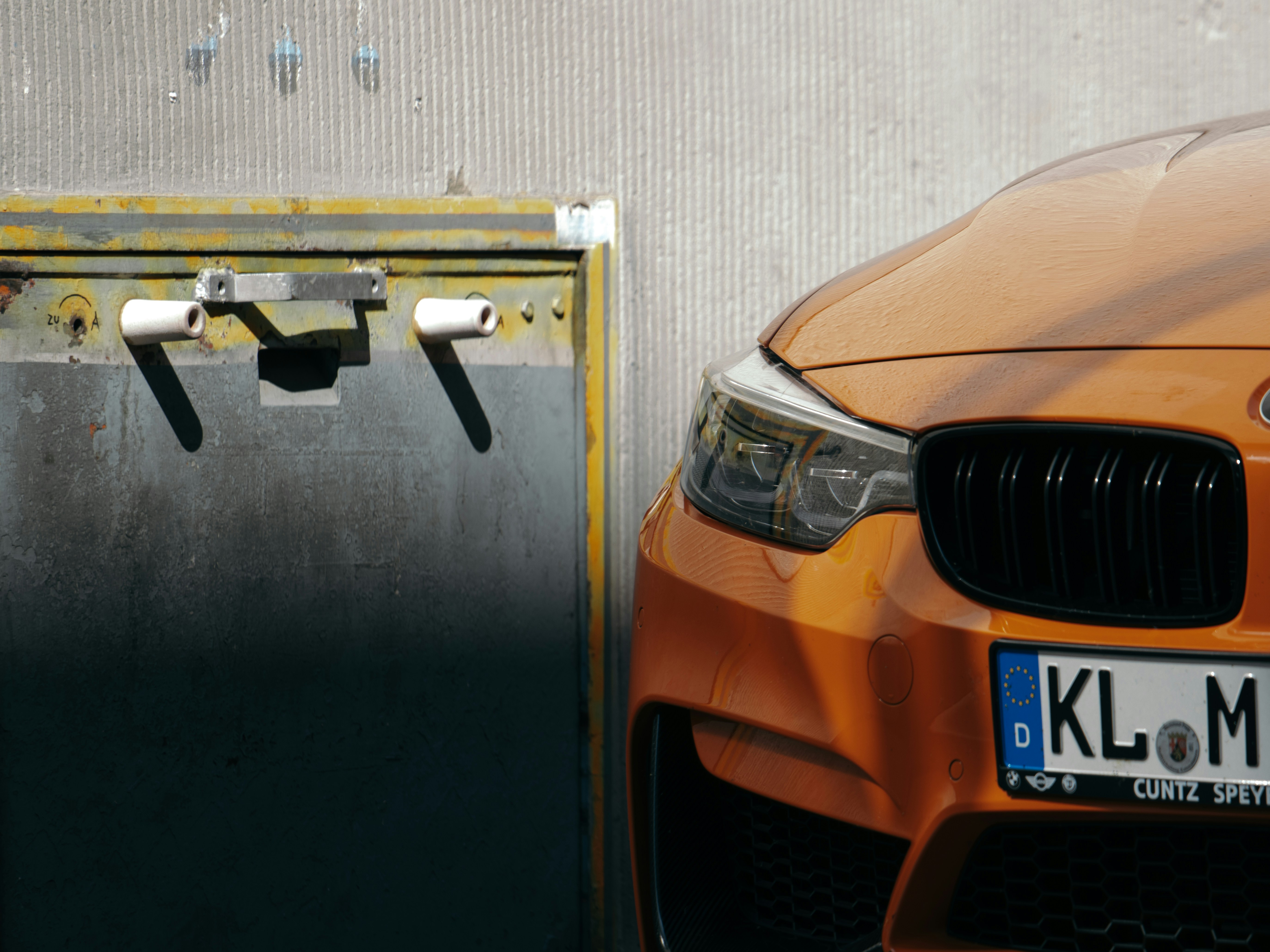 an orange car parked in front of a building