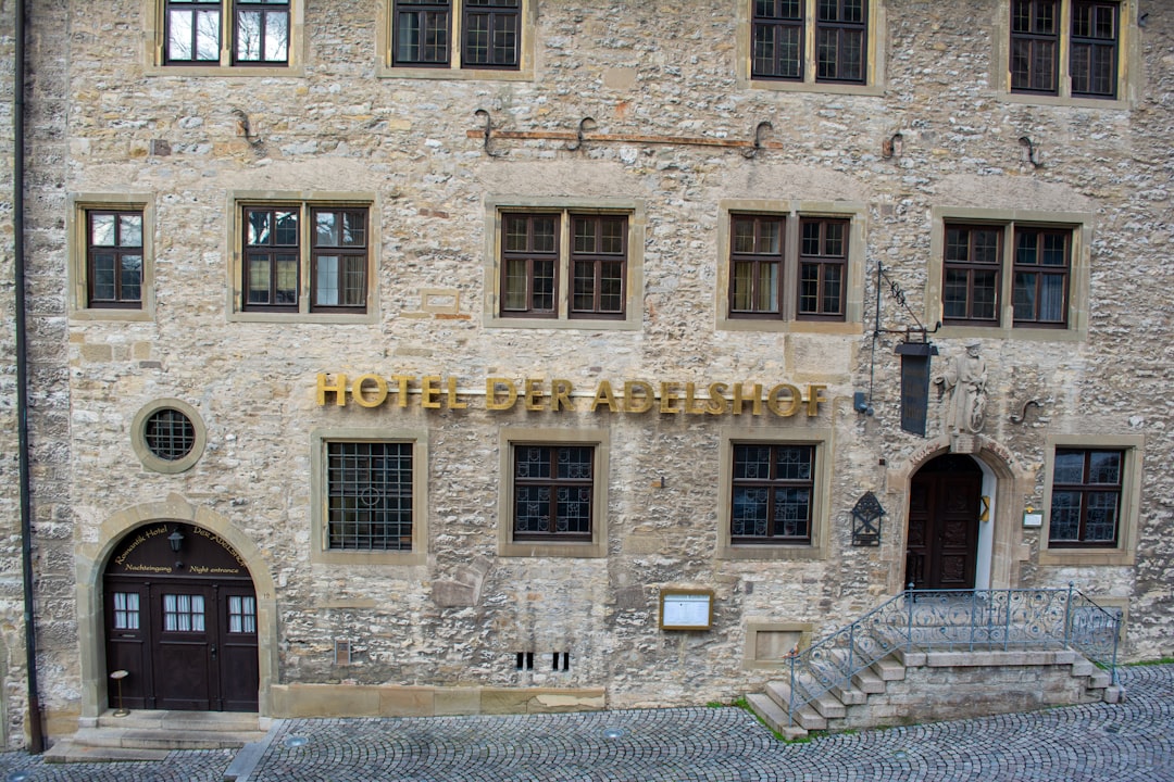 a stone building with a hotel sign on it's side