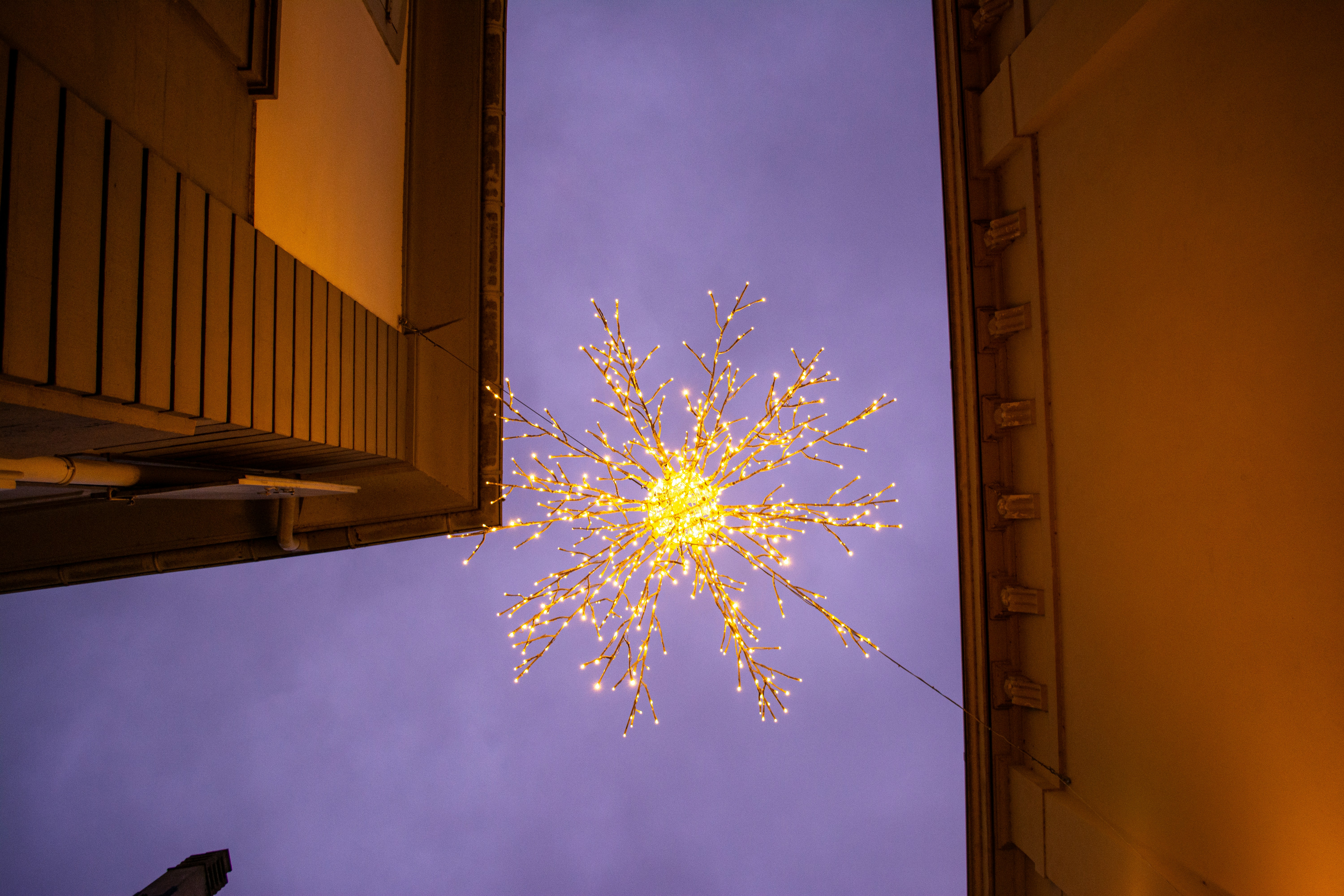a snowflake is seen in the sky above a building