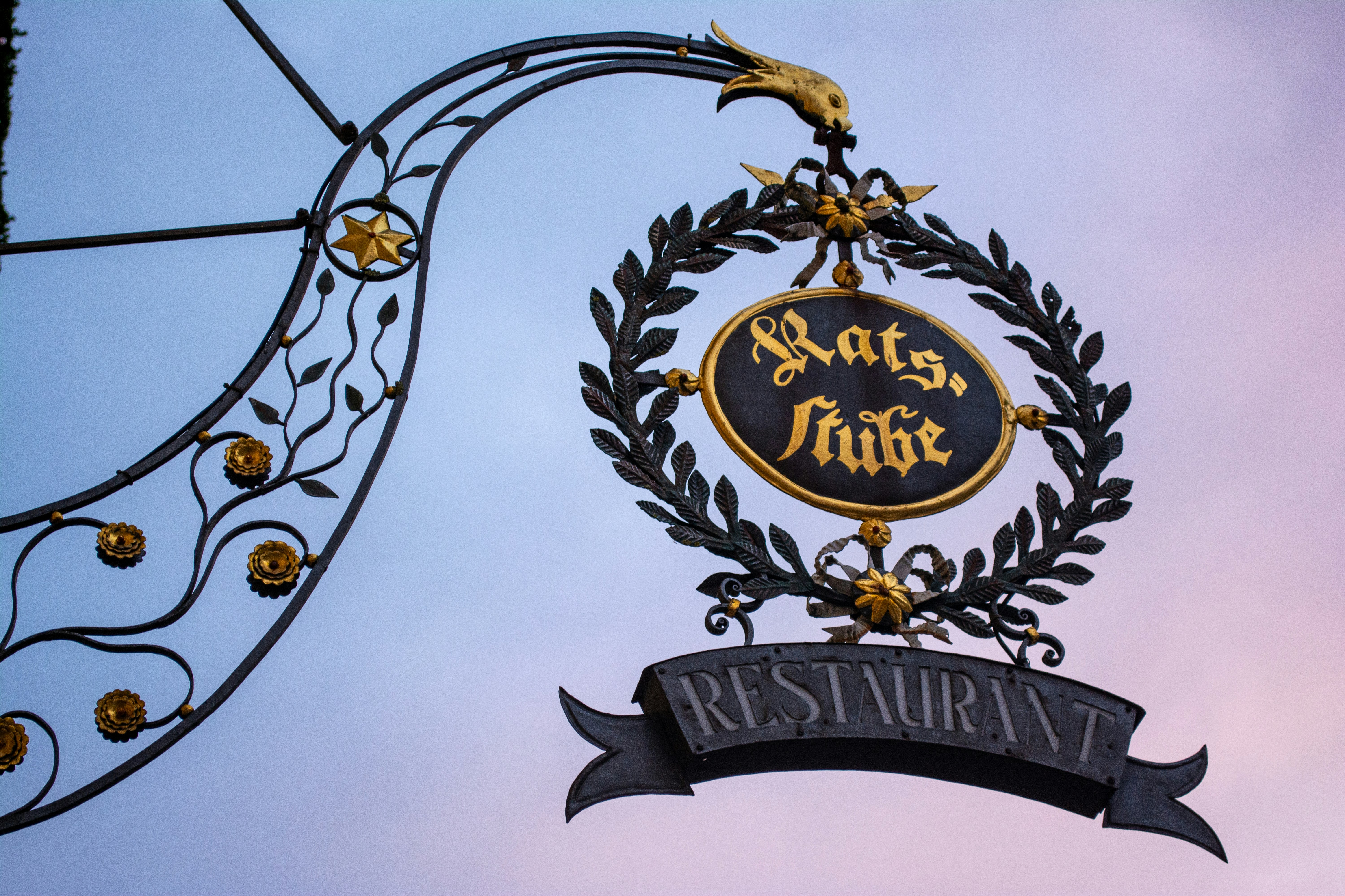 a restaurant sign hanging off the side of a building