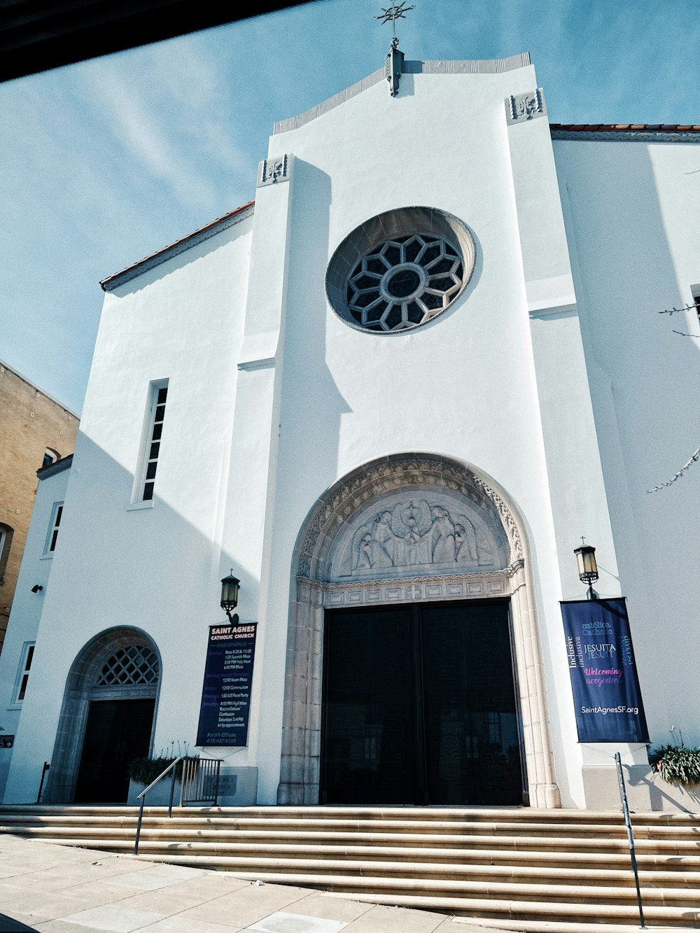 a large white church with a clock on it's side