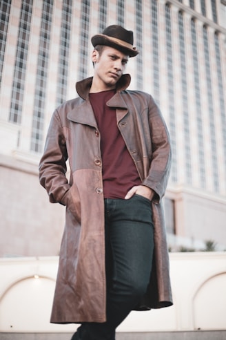 a man wearing a brown coat and hat