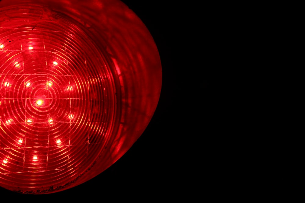 a close up of a red light in the dark