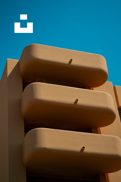 Tan Building A tan building with a blue sky in the background photo – Free Image on ...