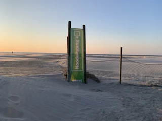 A vibrant beach sunset with a 'Special Offer' sign in the foreground.