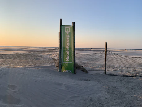 A vibrant beach sunset with a 'Special Offer' sign in the foreground.