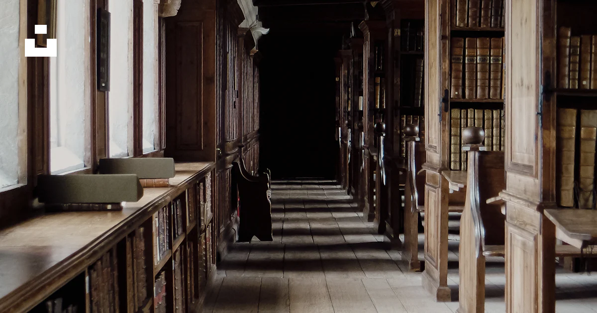 A long row of bookshelves in a library photo – Free Uk Image on Unsplash