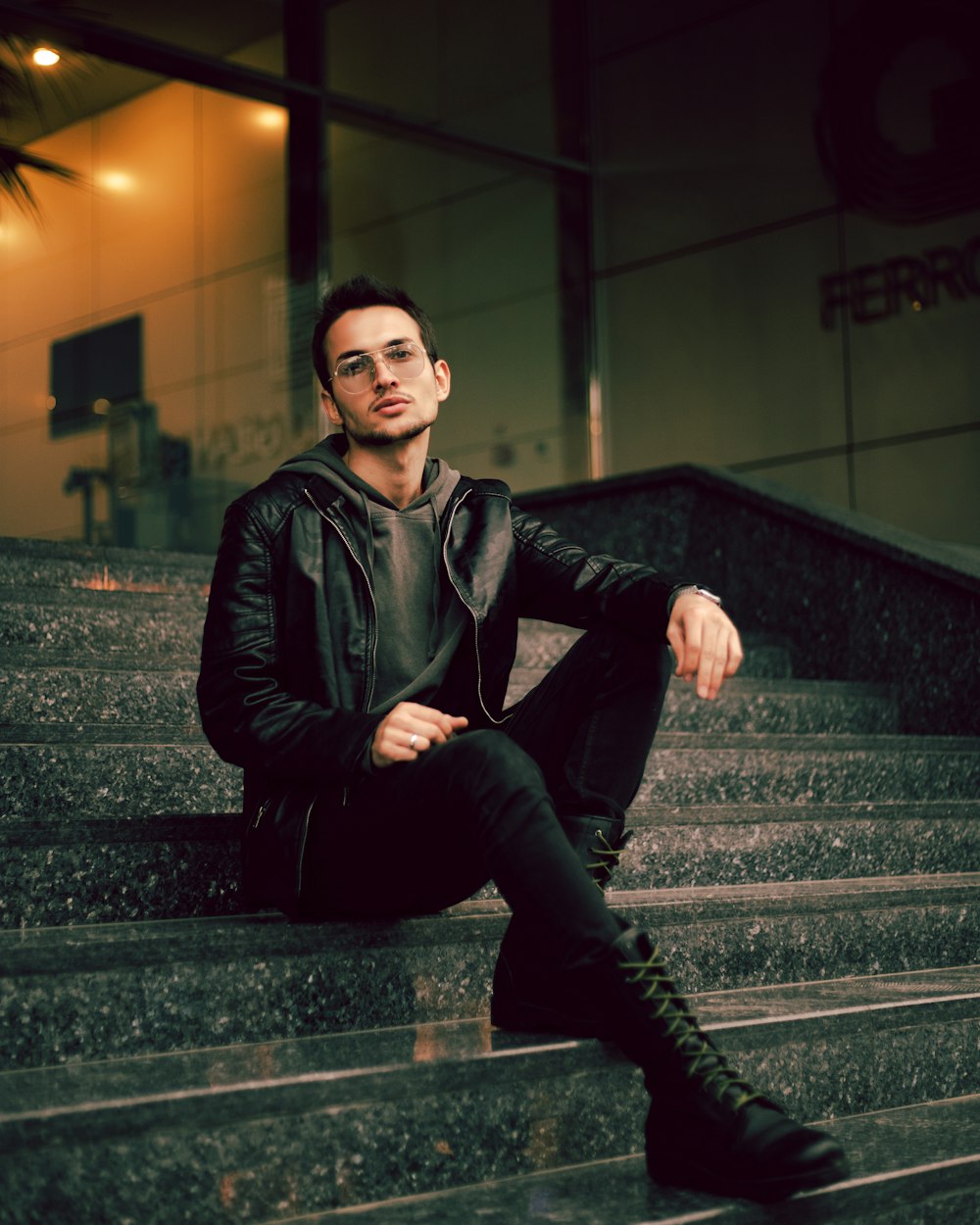 a man sitting on the steps of a building