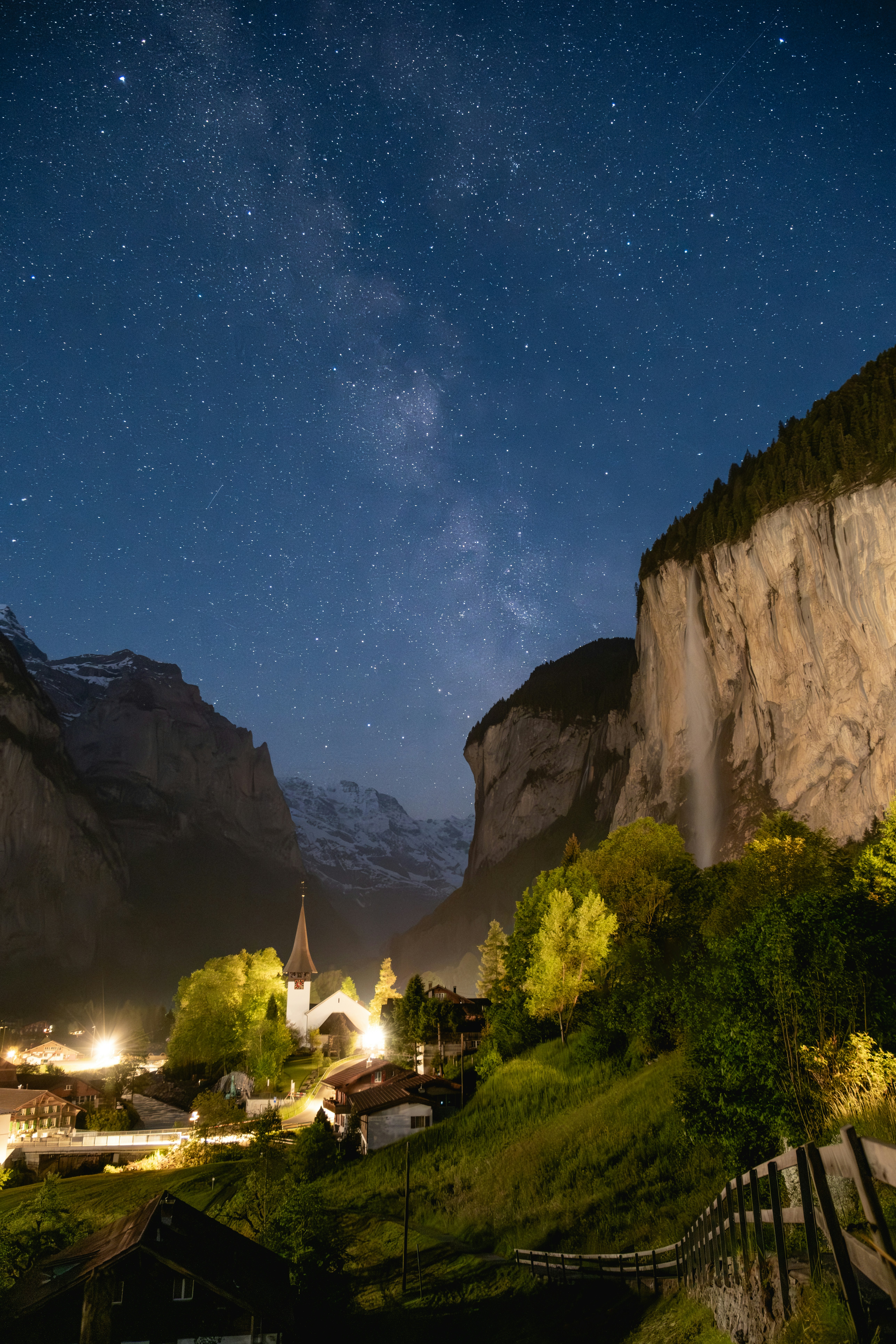 a night time view of a village and mountains