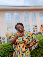 A vibrant outfit featuring bold colors and clean lines, worn by a smiling person at a lively outdoor café.